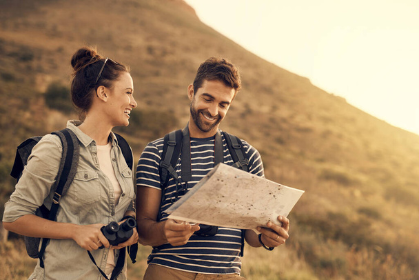 Do you even understand maps, babe. Shot of a couple looking at a map while out hiking. - 写真・画像