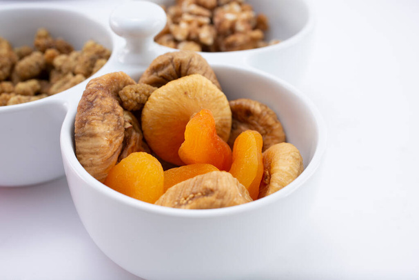 A view of a bowl of dried figs and dried apricots. - Φωτογραφία, εικόνα