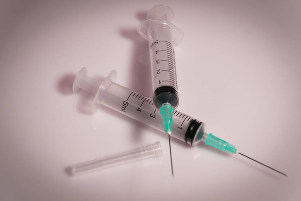 Medical syringe on a white background. A syringe for injection. The concept of health and beauty - 写真・画像