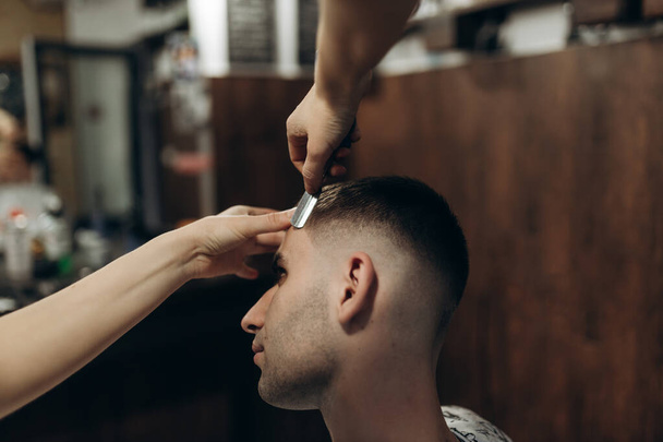 man getting his hair cut at barbershop - Valokuva, kuva