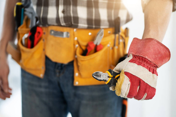Repairman holding side cutters in hand - Фото, зображення