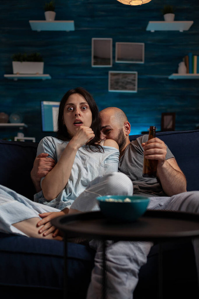 Couple watching scary horror movie on television channel - Photo, Image