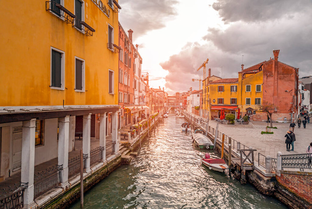 Venice, Italy - April 2, 2022: Beautiful canals and traditional Venetian buildings in Venice, Veneto, Northeast Italy. - Fotoğraf, Görsel