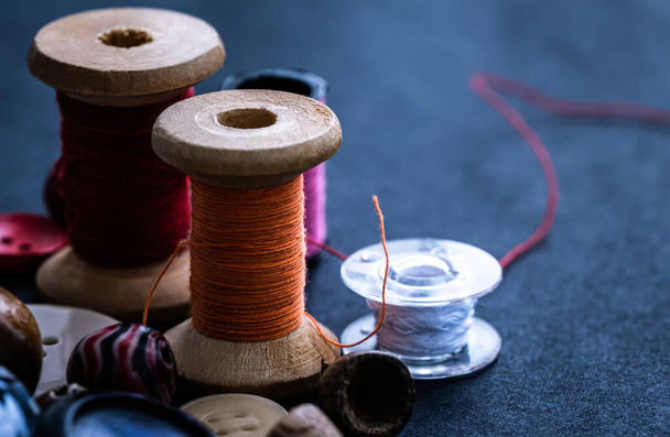 Bobbins of threads near buttons - Photo, Image