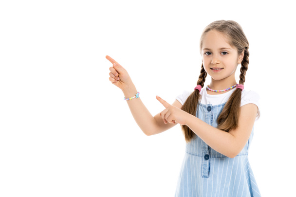 girl with braids and multicolored beads pointing away with fingers isolated on white - Photo, Image