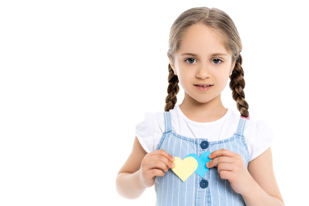 girl with blue and yellow paper hearts looking at camera isolated on white - Photo, Image