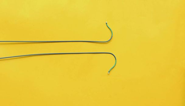 Angioplasty guiding catheters(AL-2 catheter) used to treat blockages of the arteries of heart . Image isolated on a yellow background - Photo, Image