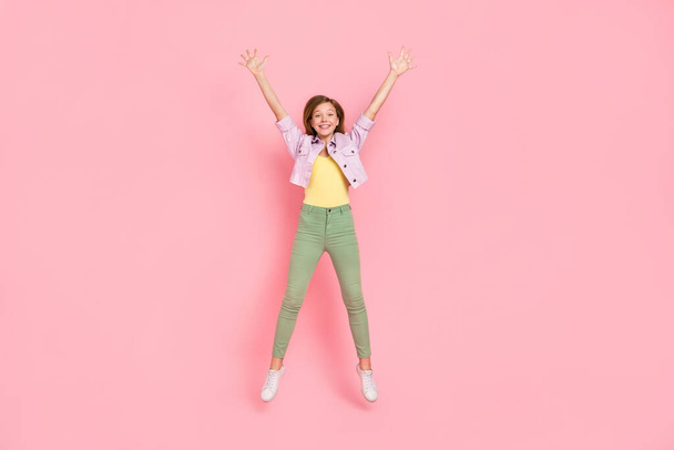 Photo of excited glad cheerful pretty lady jump raise hands wear casual jacket isolated pink color background - Photo, Image