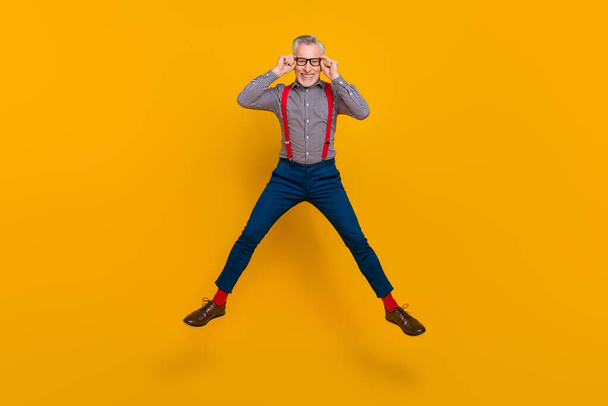 Full body photo of energetic laughing confident businessman in spectacles isolated on yellow color background - Valokuva, kuva