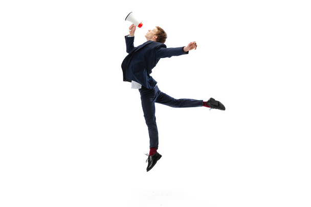 Studio shot of young male ballet dancer wearing business suit dancing isolated on white studio background. Business, start-up, art, work, caree, inspiration concept. - Фото, зображення