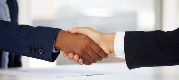 I couldnt ask for a better deal. Shot of two unrecognisable businessmen shaking hands in a modern office. - Photo, Image