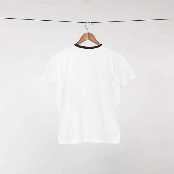 Blank White T-Shirts Mockup hanging on grey wall, 3D Rendering - 写真・画像