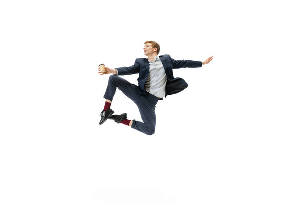 Portrait of flexible man in business style clothes dancing isolated on white studio background. Business, start-up, open-space, inspiration concept. - Fotografie, Obrázek