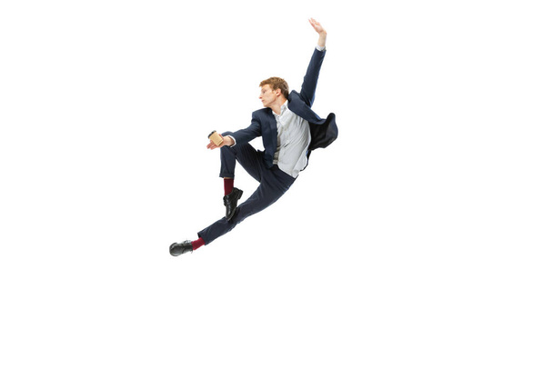 Studio shot of young male ballet dancer wearing business suit dancing isolated on white studio background. Business, start-up, art, work, caree, inspiration concept. - Foto, imagen