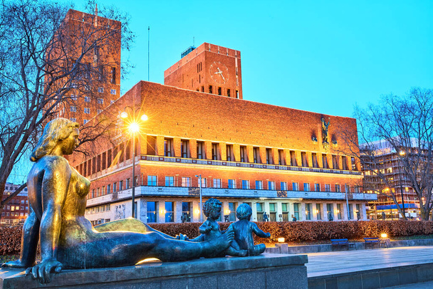 Statue in front of Oslo City Hall Radhuset at dusk, Norway - Photo, Image