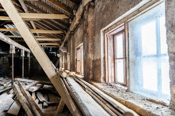 Interior of Old abandoned warehouse, window light - Pile of wood planks - Foto, Bild