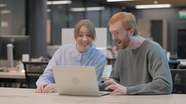 Young Man and Woman Celebrating Success on Laptop  - Photo, Image