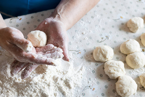 Womans hands rolling the dough for pies. Baking at home - Фото, изображение