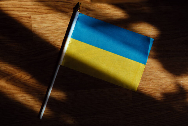 flag of ukraine blue yellow on table wooden background. - Valokuva, kuva