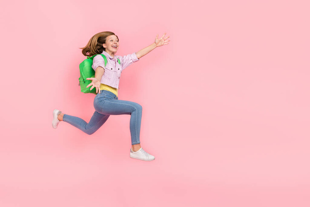 Profile photo of surprised funky lady jump catch empty space wear backpack jacket isolated pink color background - 写真・画像