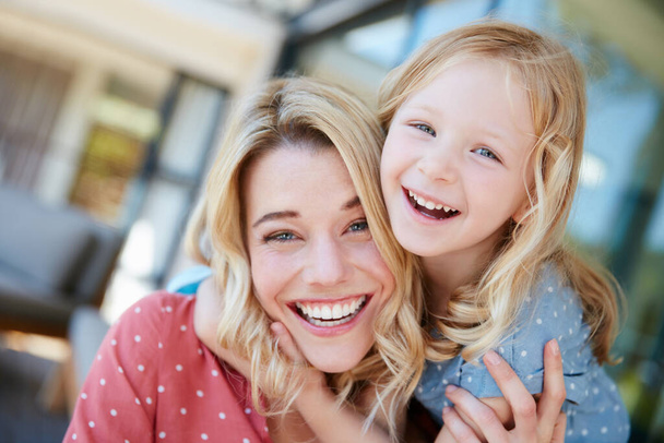 Joyful moments with Mom. Portrait of a mother and daughter spending quality time together outside. - Foto, Imagen
