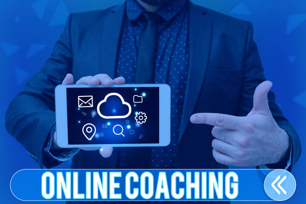 Inspiration showing sign Online Coaching. Concept meaning Learning from online and internet with the help of a coach Man holding Screen Of Mobile Phone Showing The Futuristic Technology. - 写真・画像