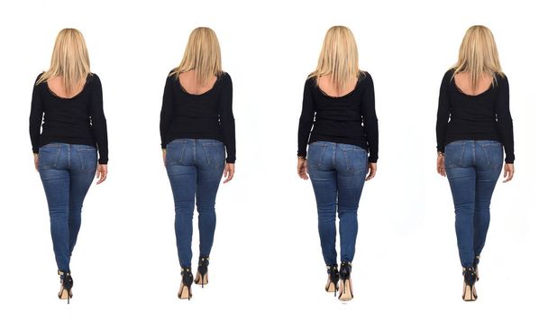 rear view of same woman walking with jeans and heeled shoes on white background - Foto, imagen