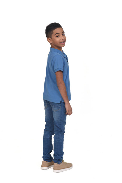 rear view of boy turned and looking at camera on white background - Photo, Image