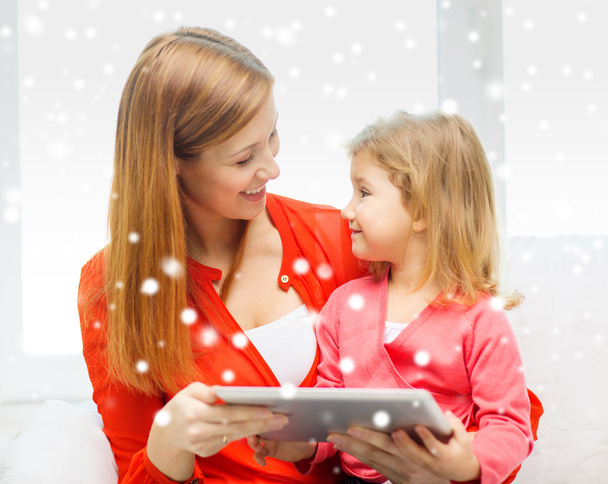 happy mother and daughter with tablet pc computer - Valokuva, kuva
