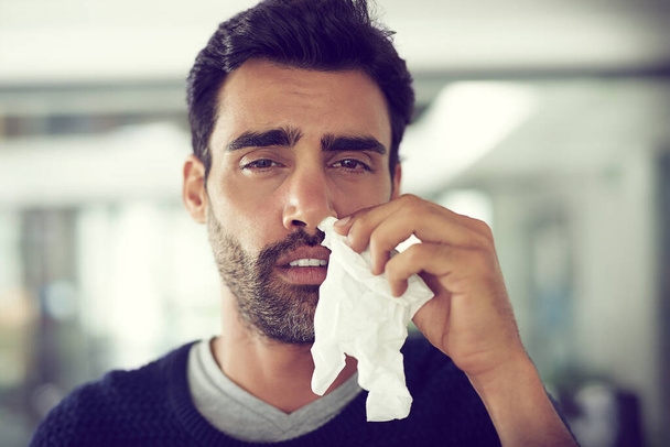 Its allergy season. Portrait of a designer suffering with allergies in an office. - Foto, Imagen
