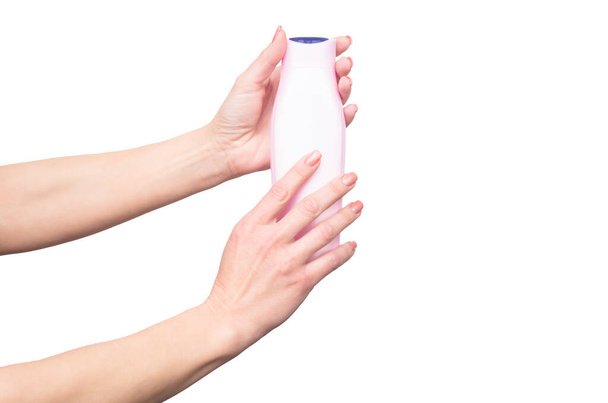 female hands hold shampoo bottle with copy space - Photo, image