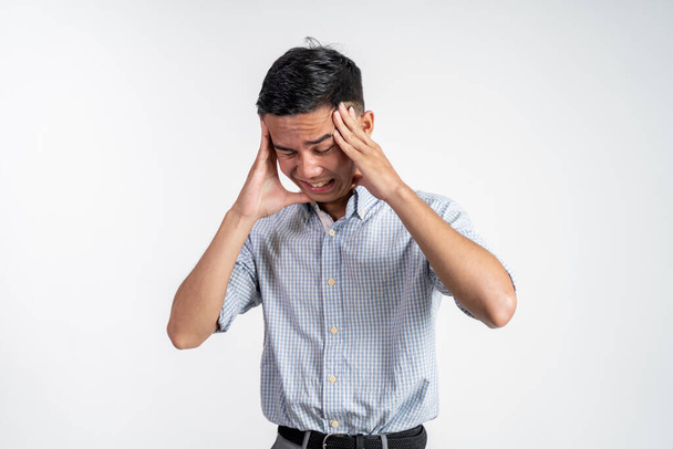 Stressed asian young young man holding head - Foto, immagini