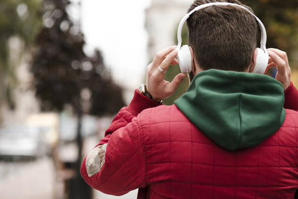 young man listening to music with headphones in the park - Photo, image
