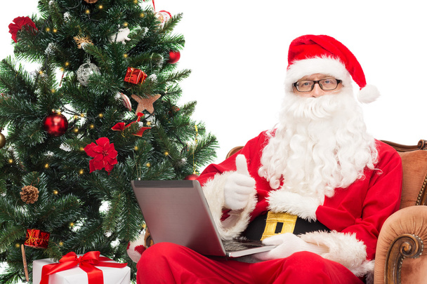 man in costume of santa claus with laptop - Фото, изображение
