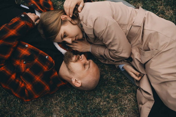 young couple laying on grass. summer love - Photo, Image