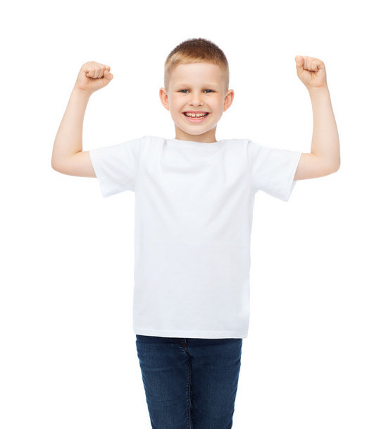 little boy in blank white t-shirt showing muscles - Foto, afbeelding