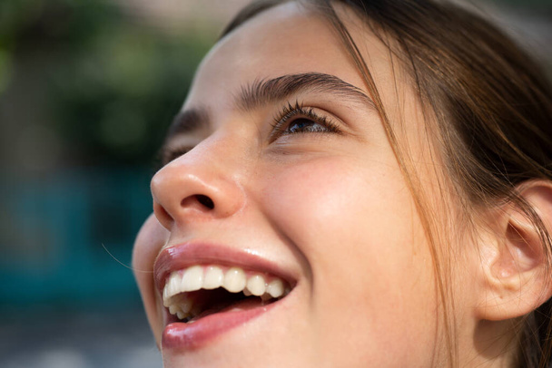 Laughing woman. Portrait of happy smiling girl. Cheerful young beautiful girl smiling laughing outdoor. Emotional face closeup. - Zdjęcie, obraz