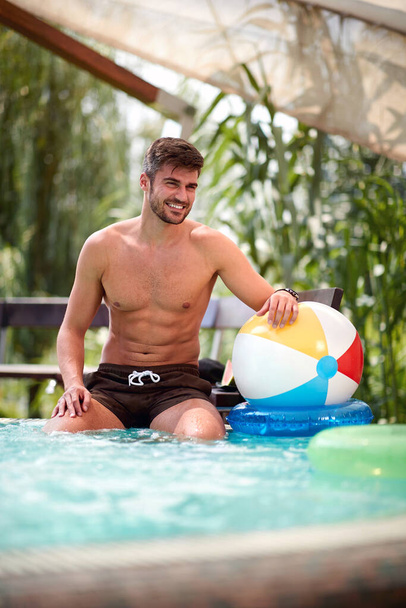 Handsome young man on swimming pool  - Foto, Bild