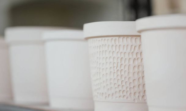 Plain handmade ceramics with soft pastel color toned.Macro shot with soft focus and very shallow depth of field, some objects out of focus. - Photo, Image