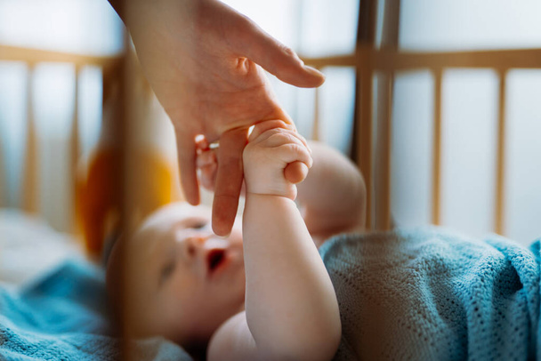 Baby toddler holding mothers hand. Holding hand of newborn child - Valokuva, kuva