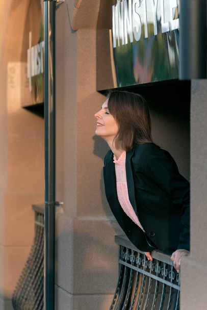 Portrait of woman office worker breathing in fresh air on balcony. Break from work. Formal attire - Photo, Image