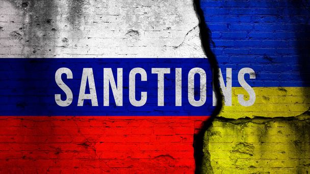 Sanctions against Russia because of war in Ukraine concept background with text. Flag background, cracked brick wall  - Фото, изображение