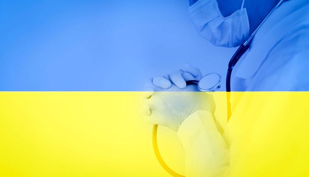 Flag Ukraine with Doctor man praying and worshiping hands in worship to GOD on White background, folded hands in prayer concept for faith, spirituality and religion, hands raised in worship background - 写真・画像
