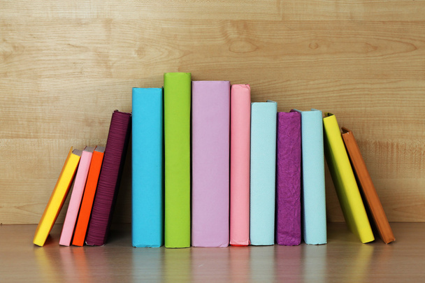 Books on wooden shelf - Фото, зображення