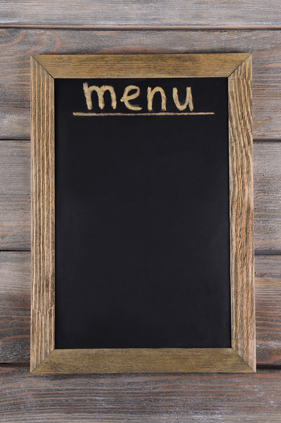 Inscription menu on chalkboard on table close-up - Фото, изображение
