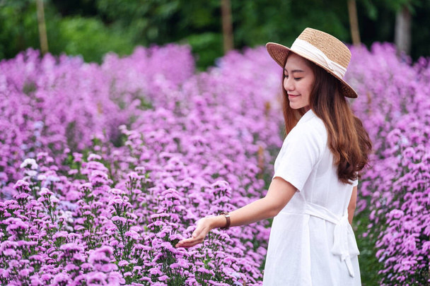Portrait image of a beautiful young asian woman in Margaret flower field - Photo, Image