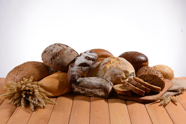 Fresh bread on table on white background - Foto, Imagen
