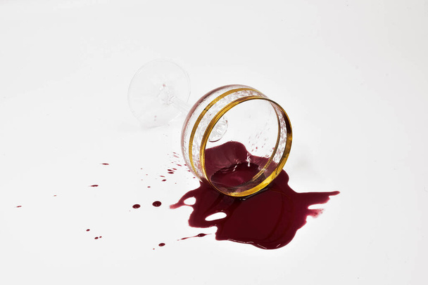 A glass with spilled red wine - Foto, imagen