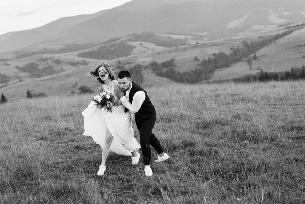 black ans white image of young wedding couple in love posing  - 写真・画像