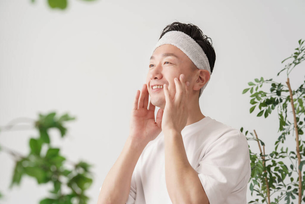 Asian middle man massaging the face with his hands - Photo, Image